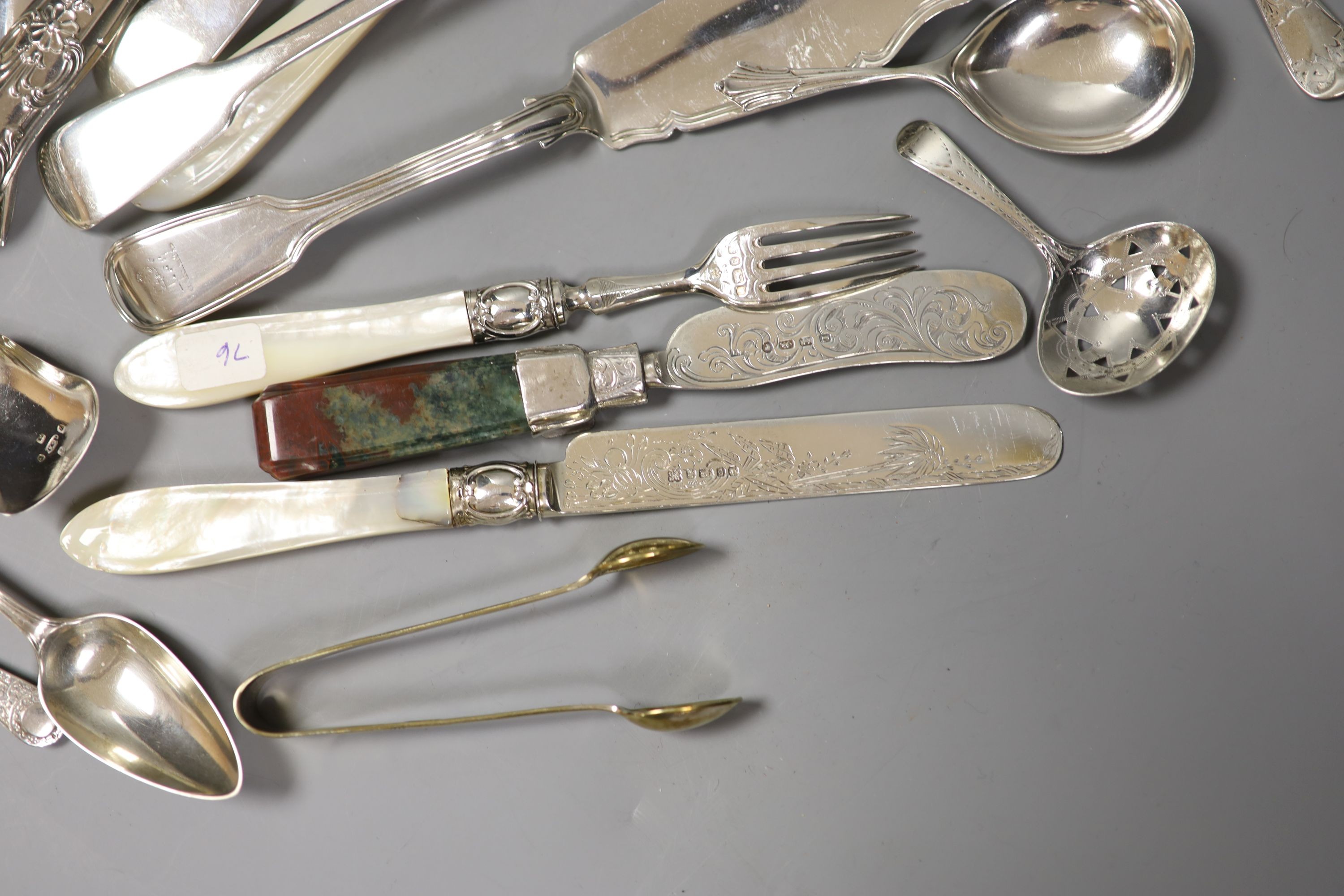 Four Victorian and later silver butter knives including Newcastle and a group of assorted silver flatware including two 19th century caddy spoons, tablespoons, letter opener and a Victorian agate handled butter knife.